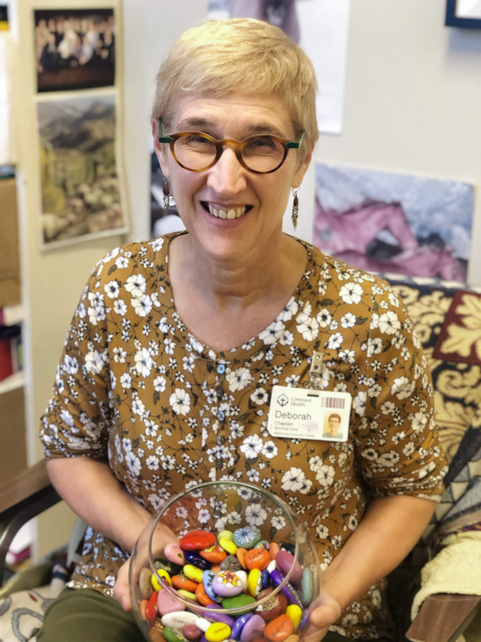 Deborah Kirkpatrick holds the rock bowl filled with painted rocks.