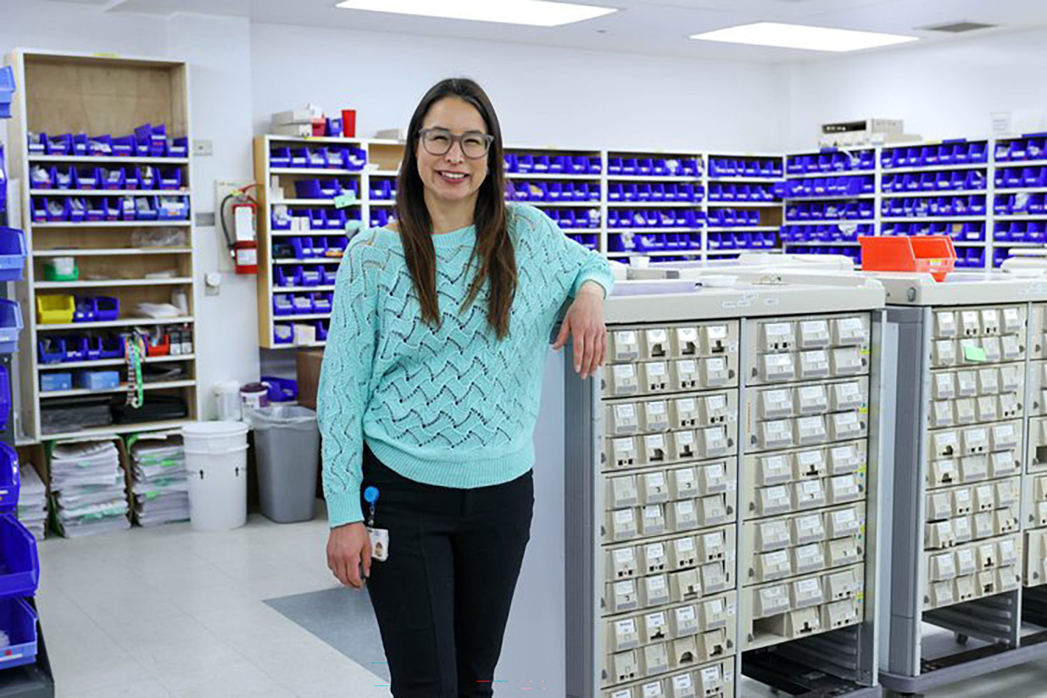 Amber Ruben poses smiling in the pharmacy storage room.