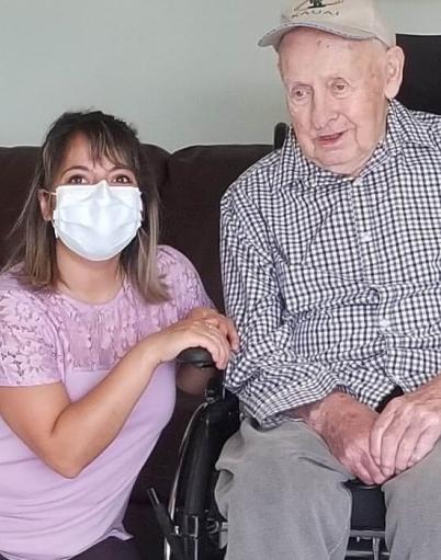 Occupational therapist Sheren Cherri poses with resident Guenter Bork